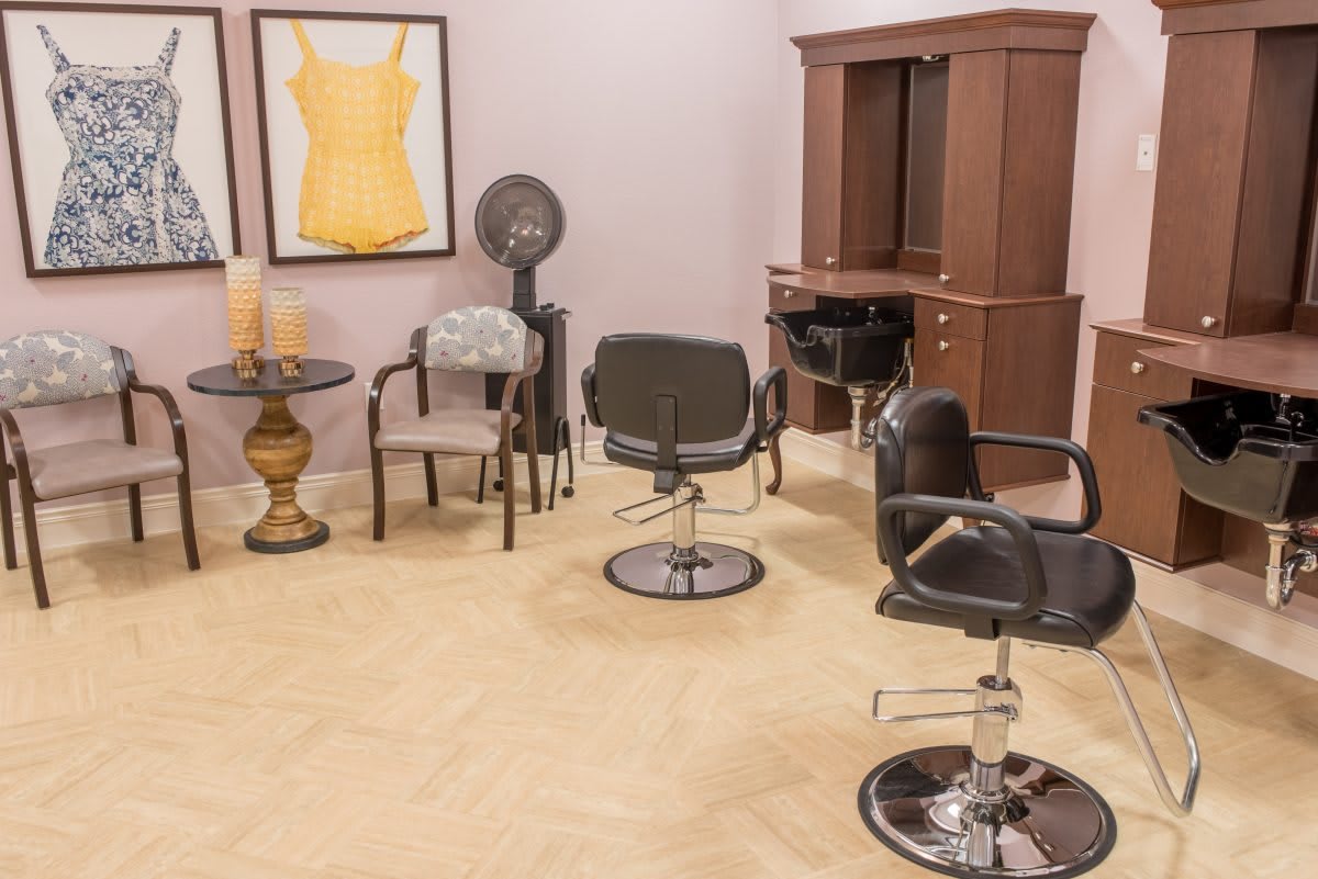 A cozy hair salon with styling stations and chairs.