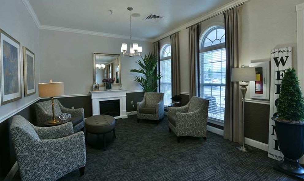 A cozy living room with comfortable seating and large windows.