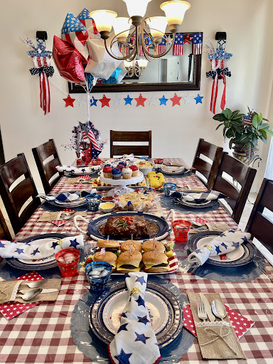 A beautifully decorated dining table ready for a festive family gathering, complete with a patriotic theme.