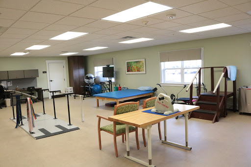 A spacious rehabilitation therapy room equipped with exercise equipment and a bright, inviting atmosphere.