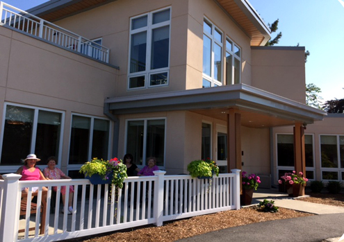 A charming two-story house with a welcoming exterior and colorful flower arrangements.