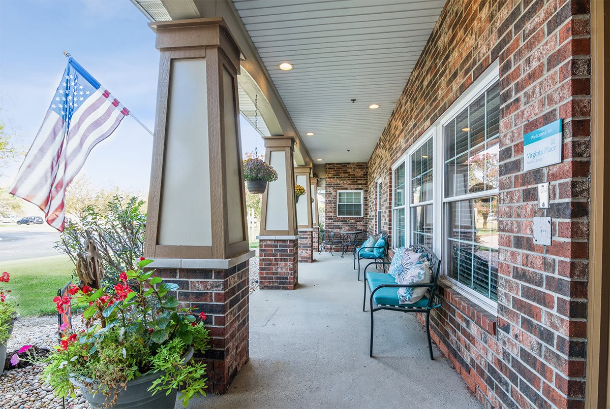 A spacious porch with brick details and comfortable seating.