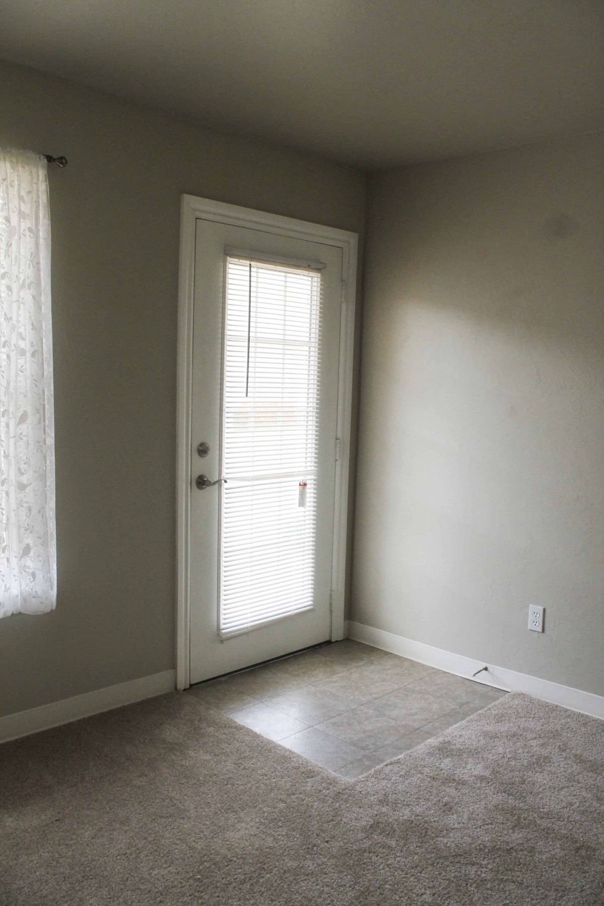 A room with a glass door allowing natural light to enter.