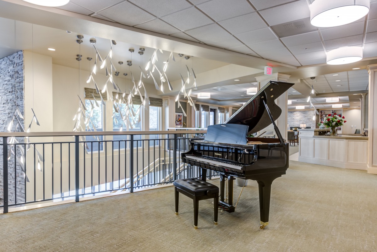 A grand piano positioned in a modern lobby setting.