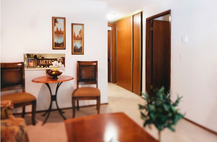 Cozy interior hallway with wooden furniture and decorative artwork on the walls.