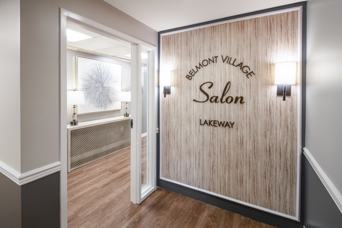 Entrance to a salon with wood paneling and elegant signage.