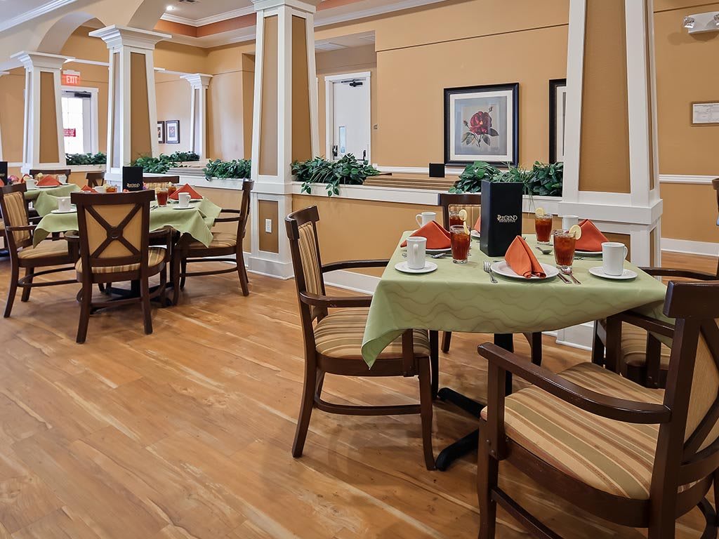 A well-decorated dining area with neatly arranged tables and chairs, set for guests.