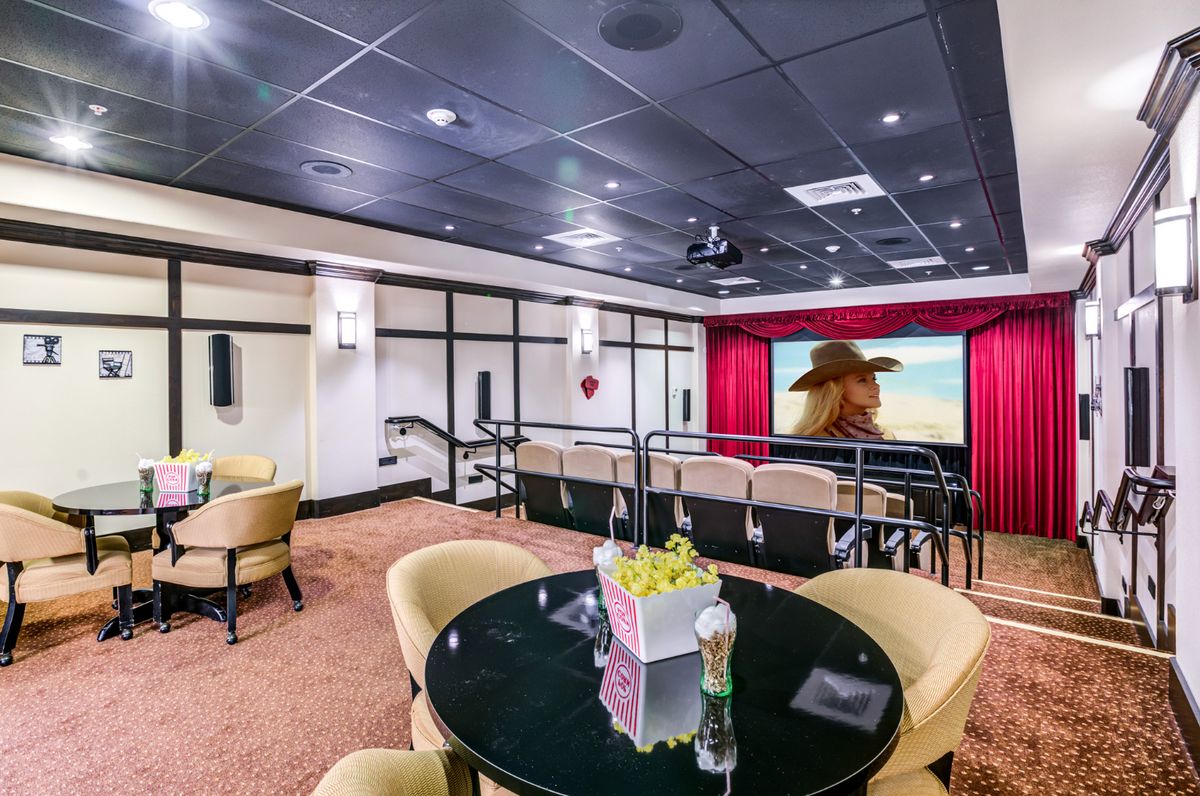 A luxurious home theater with comfortable seating and a large projection screen.