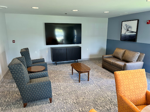 A cozy living room setup featuring a television, comfortable seating, and a warm atmosphere.