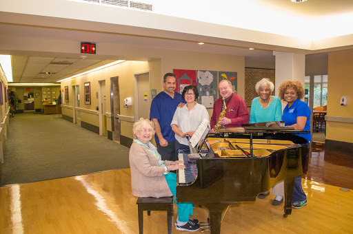 A joyful gathering around the piano, where friends share music and laughter.