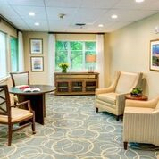 A cozy waiting room with comfortable seating and a large window.