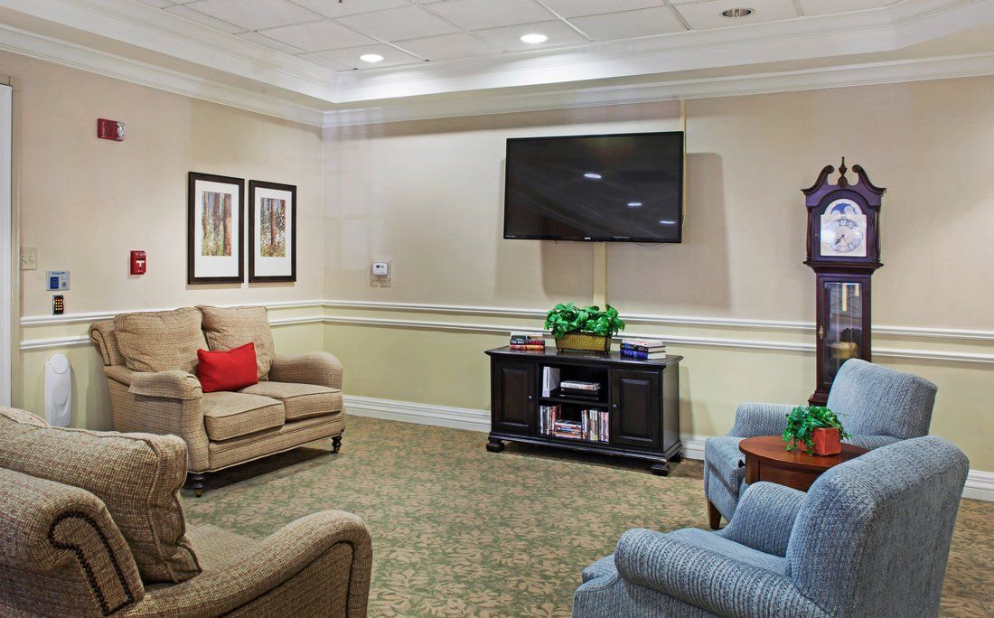 A cozy living room with comfortable seating and a large television.