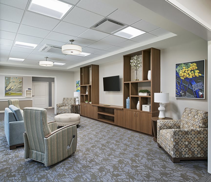 A modern living room with comfortable seating and a wall-mounted television.
