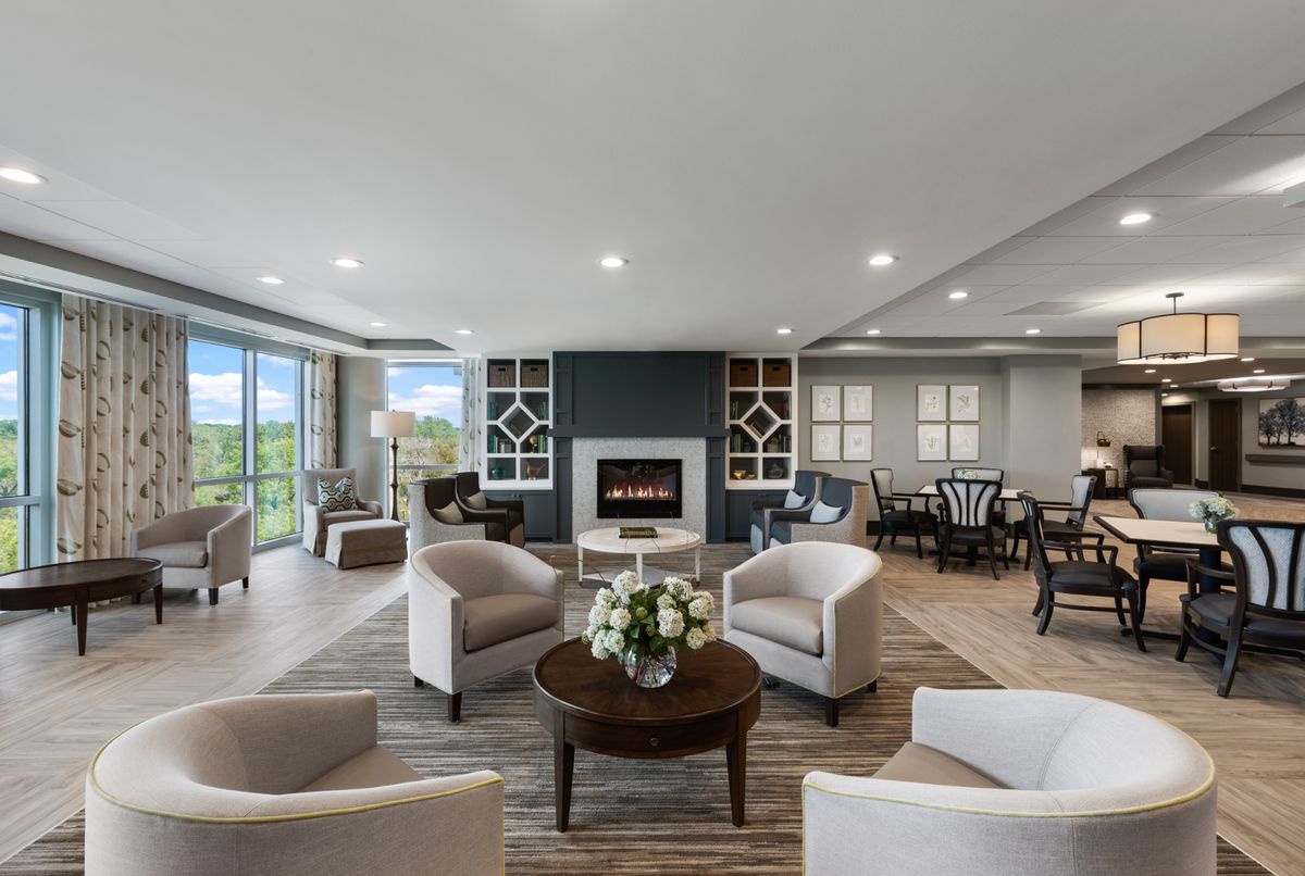 A modern living room with comfortable seating and a cozy fireplace.