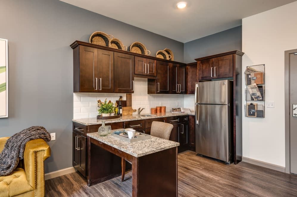 Modern kitchen with dark wood cabinets and stainless steel appliances.