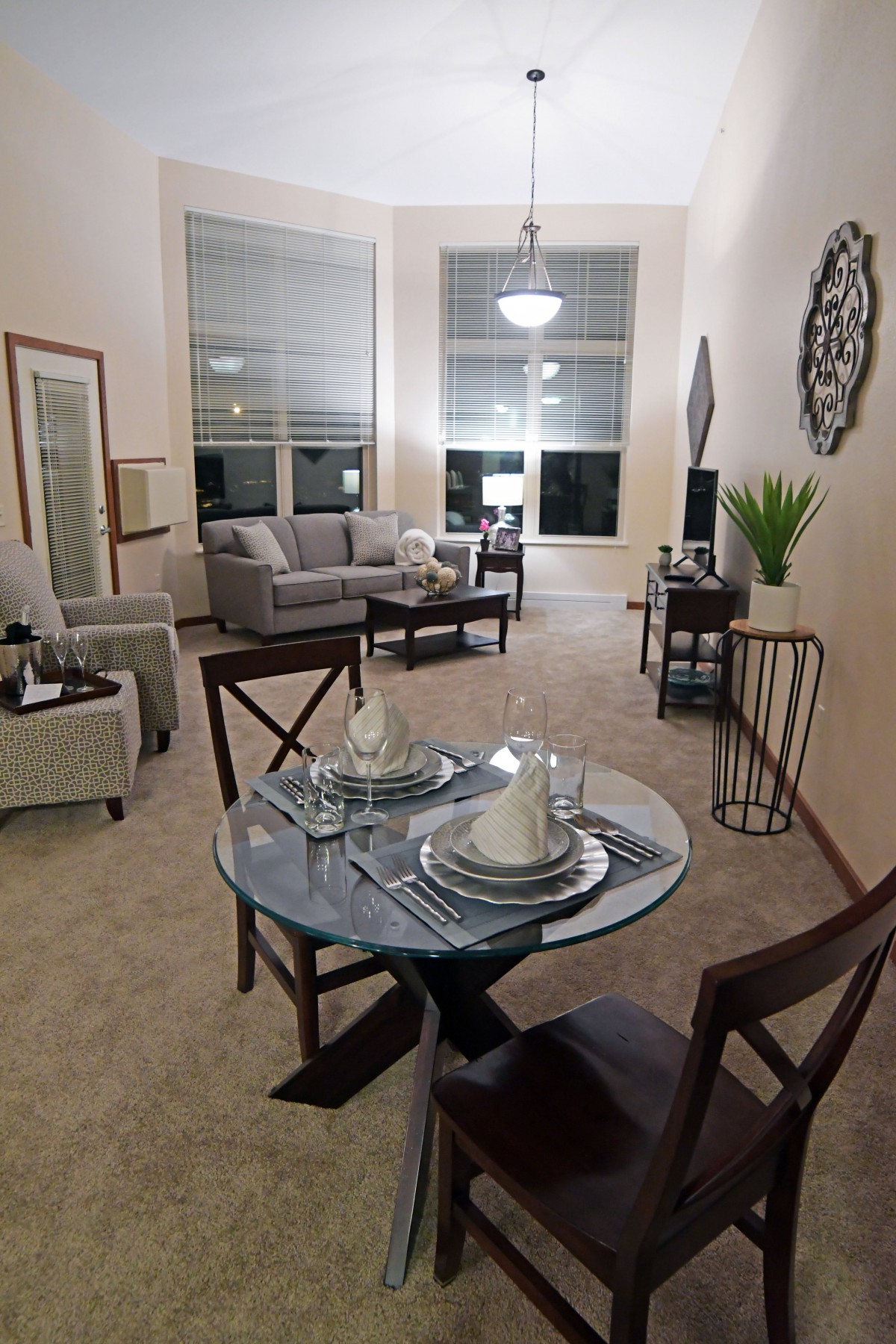 A cozy and modern living room with an adjoining dining area, featuring elegant furniture and tasteful decor.