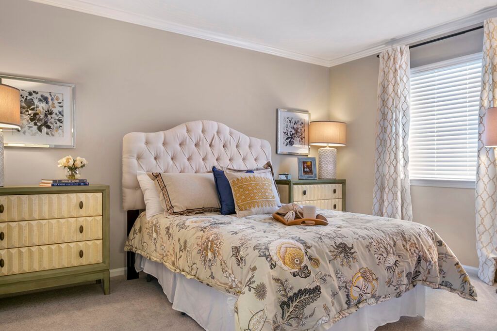 A cozy and elegantly decorated bedroom with a plush bed and stylish nightstands.