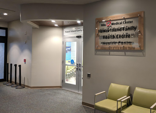 Entrance to a medical facility featuring a waiting area and informational signage.