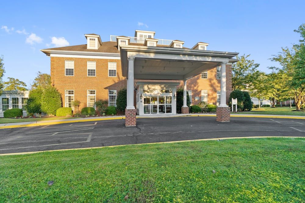 The image shows the front entrance of a brick building with a canopy.