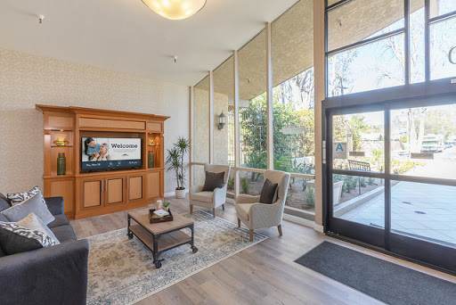 A bright and inviting lobby featuring modern furniture and large windows that allow natural light to fill the space.