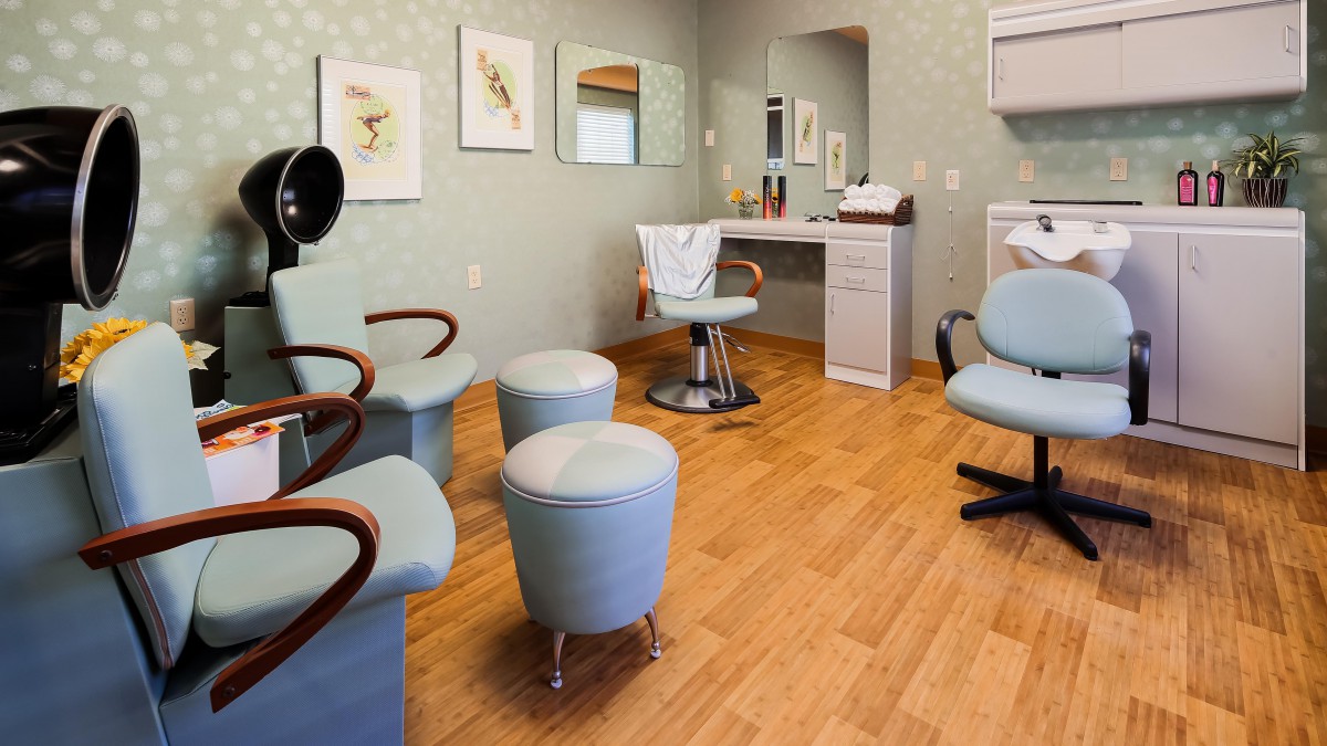 A modern beauty salon interior with styling chairs and mirrors.