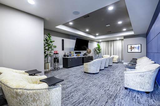 A stylish and modern home theater setup featuring comfortable seating and a sleek entertainment system.