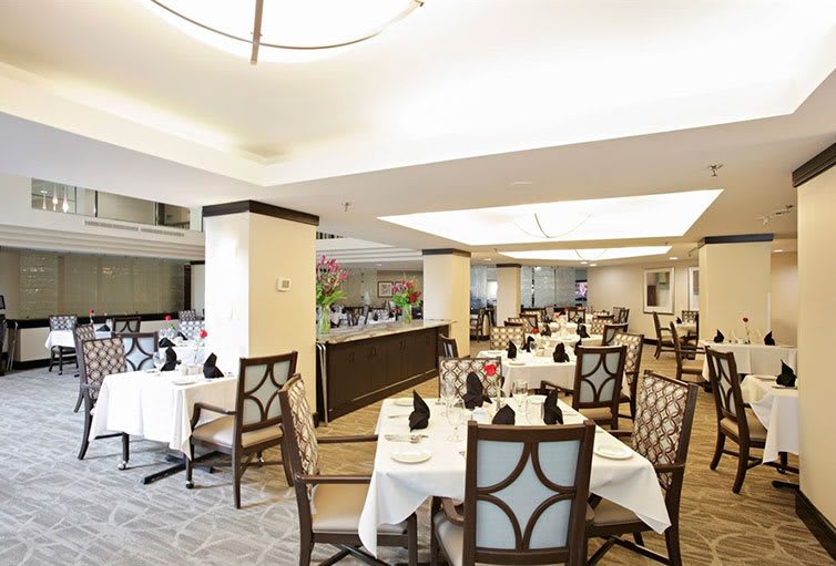 An elegant restaurant dining area with neatly arranged tables and chairs.