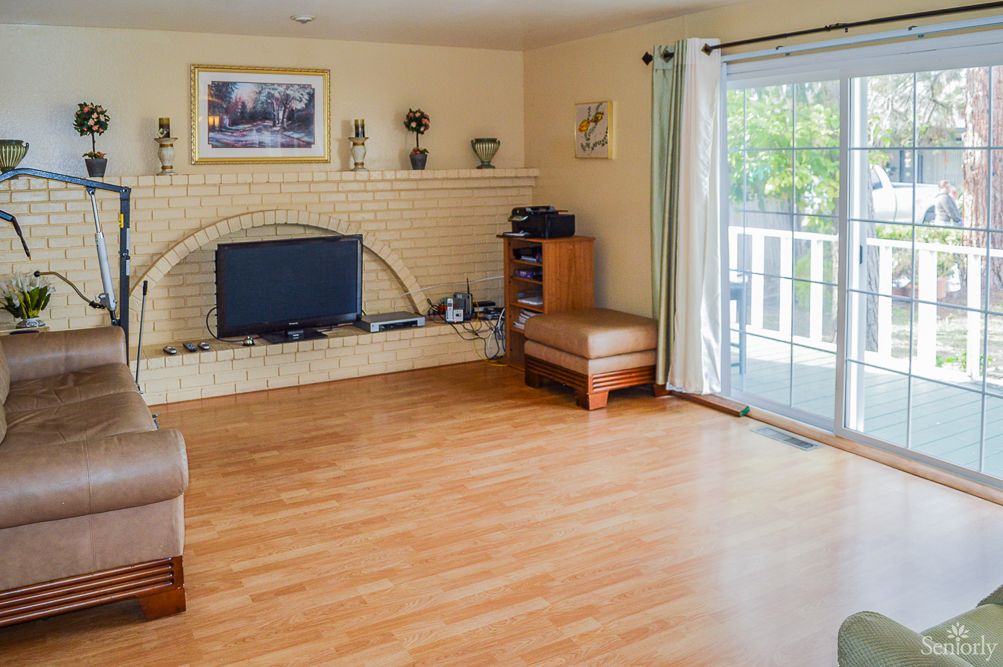 Bright and minimalist living room with hardwood floors and a sliding glass door.