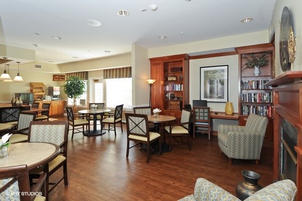 A cozy lounge area with tables, chairs, and decorative elements.