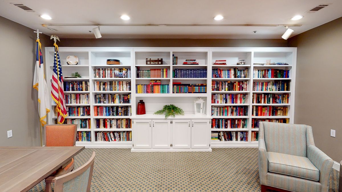A well-organized bookshelf in a cozy library setting.