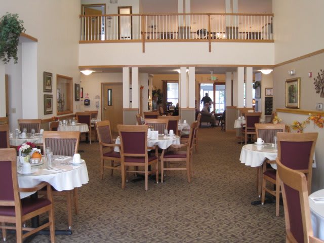 A spacious dining area with neatly arranged tables and chairs.