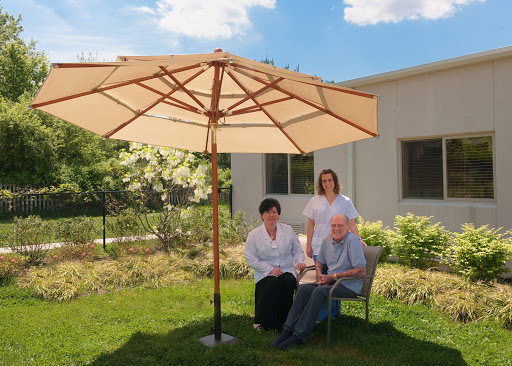 A serene moment in the garden under a large umbrella.