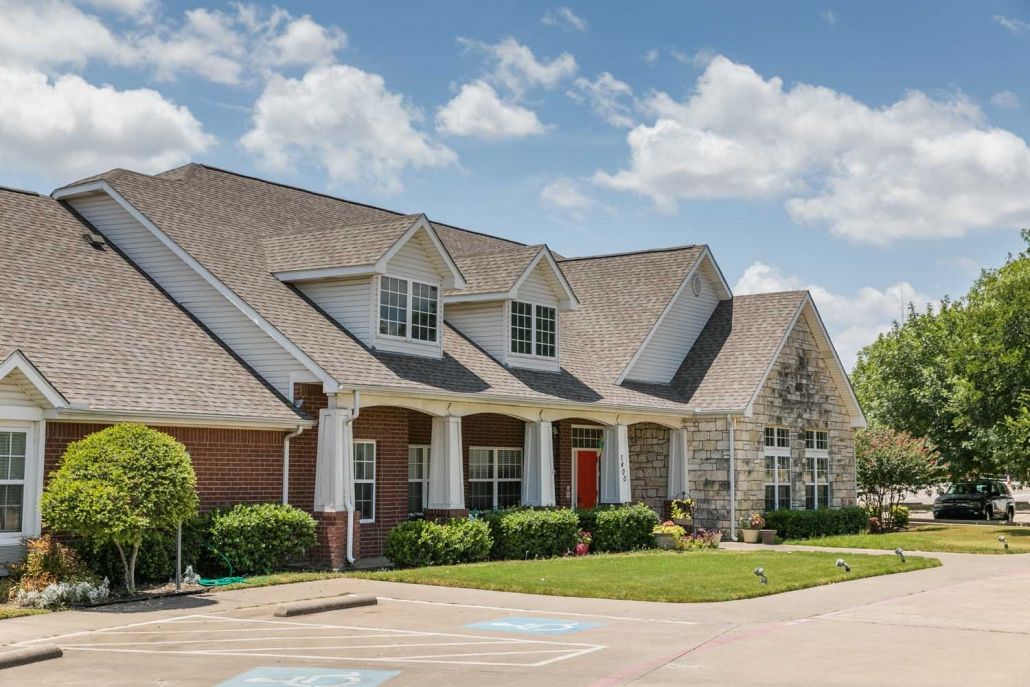A suburban house with a brick exterior and well-maintained landscaping.