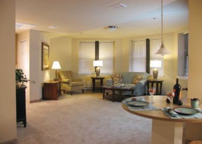 A cozy living room with comfortable seating and warm lighting.