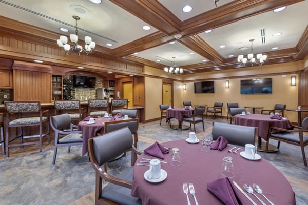 A well-arranged dining room with elegantly set tables and comfortable seating.