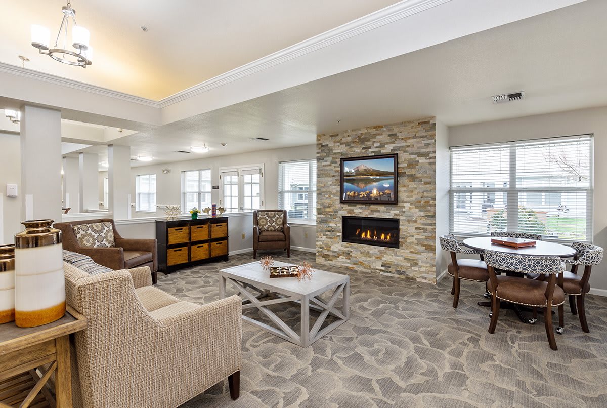 A cozy modern living room with a fireplace and stylish furniture.