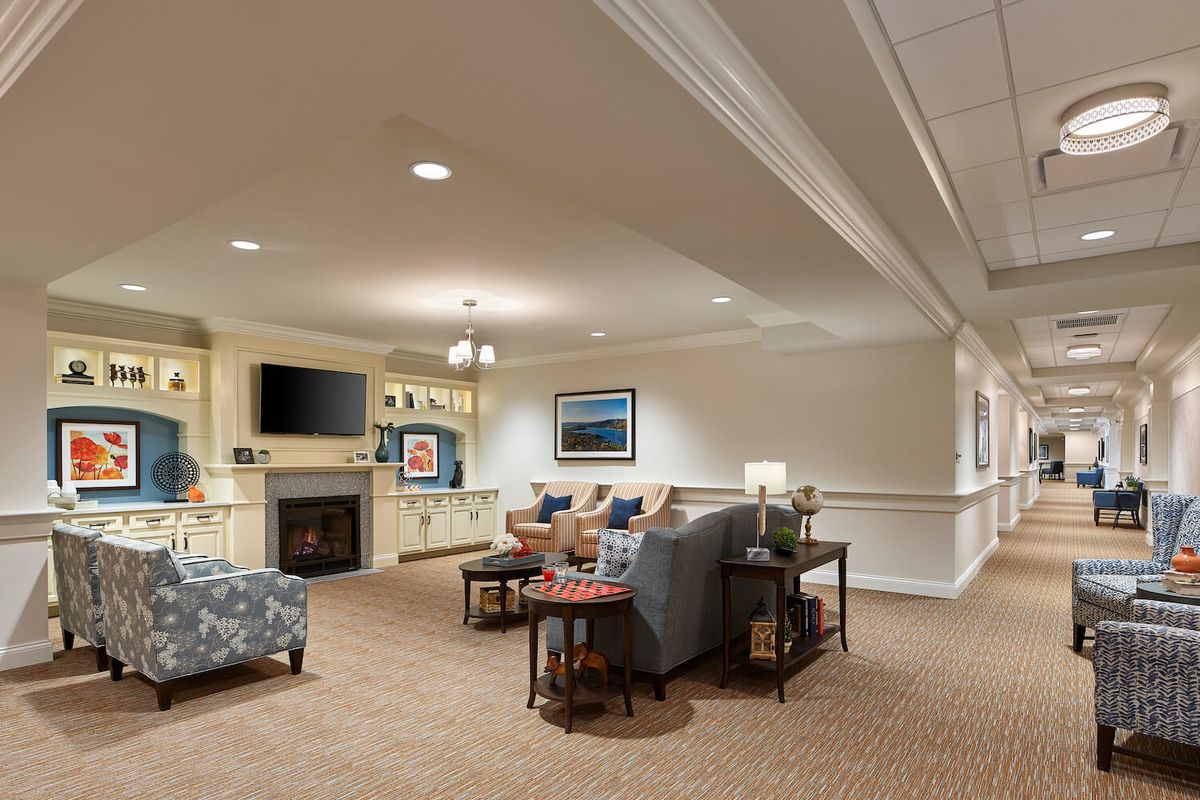 A cozy living room with comfortable seating, a fireplace, and decorative elements.