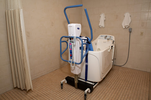 A patient lift system designed for accessibility in a bathroom setting.