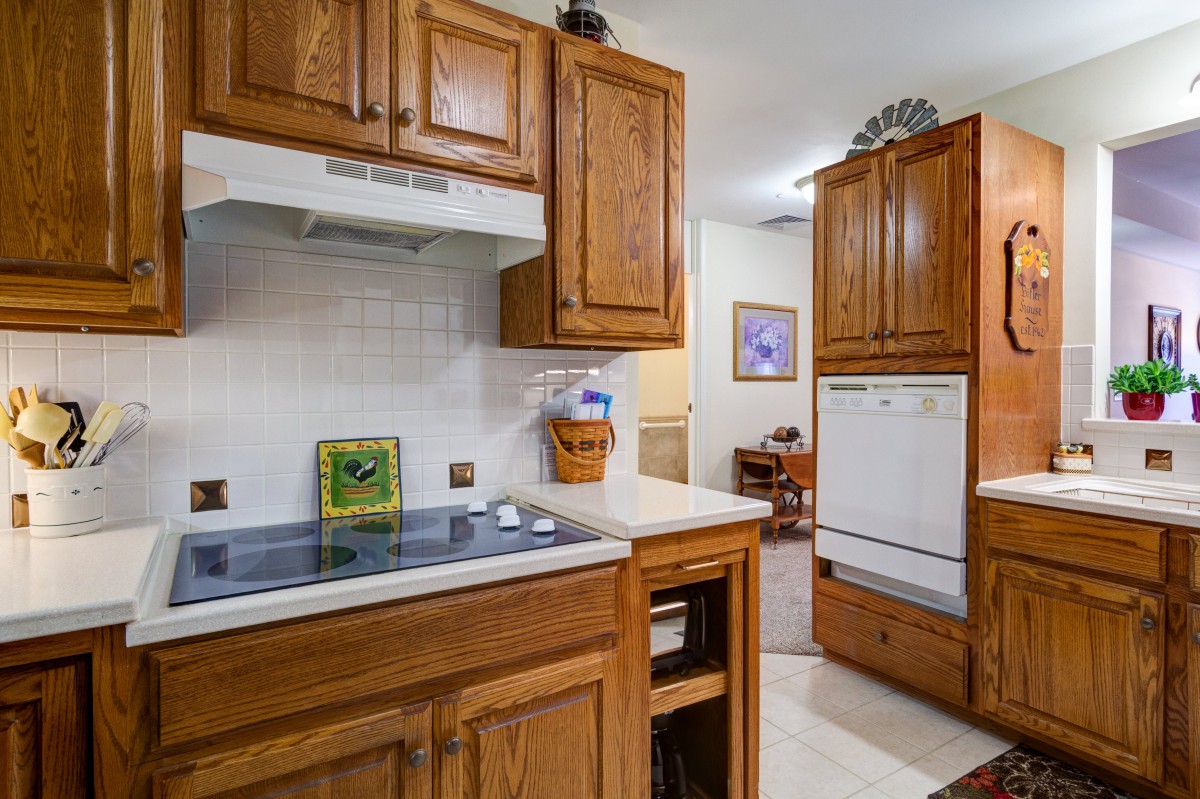 A cozy kitchen with wooden cabinets and modern appliances.