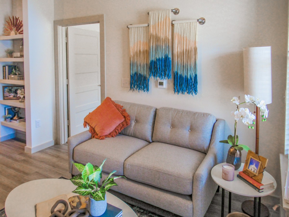 Cozy living room with a modern sofa and colorful wall art.