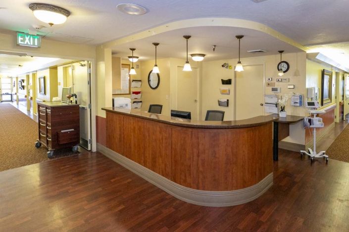 A modern reception desk with comfortable seating and ambient lighting.