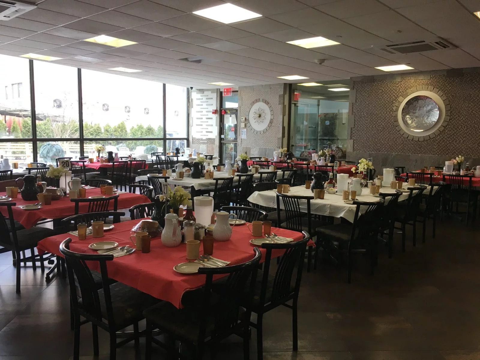 An indoor dining area with tables and chairs set up in a restaurant.