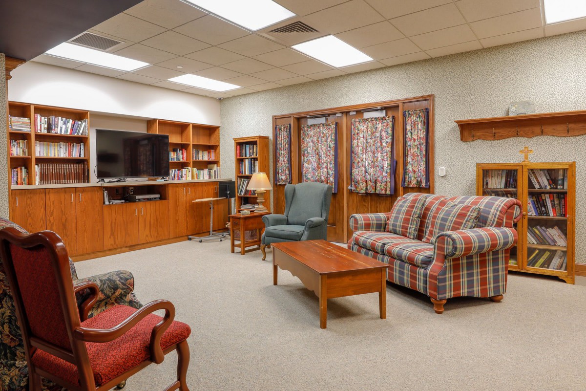 Cozy living room with a comfortable sofa, armchairs, and a large television.