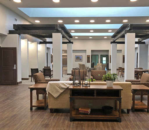 A spacious and modern lobby featuring elegant furniture and ample natural light.