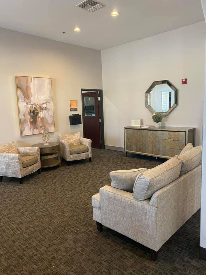 A modern waiting room with comfortable seating and elegant decor.