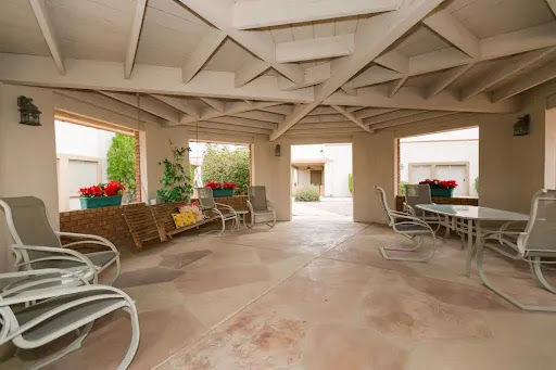 A cozy outdoor patio featuring comfortable seating and beautiful landscaping, perfect for relaxation.