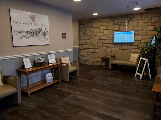 A cozy and modern lobby area featuring comfortable seating and an information screen.