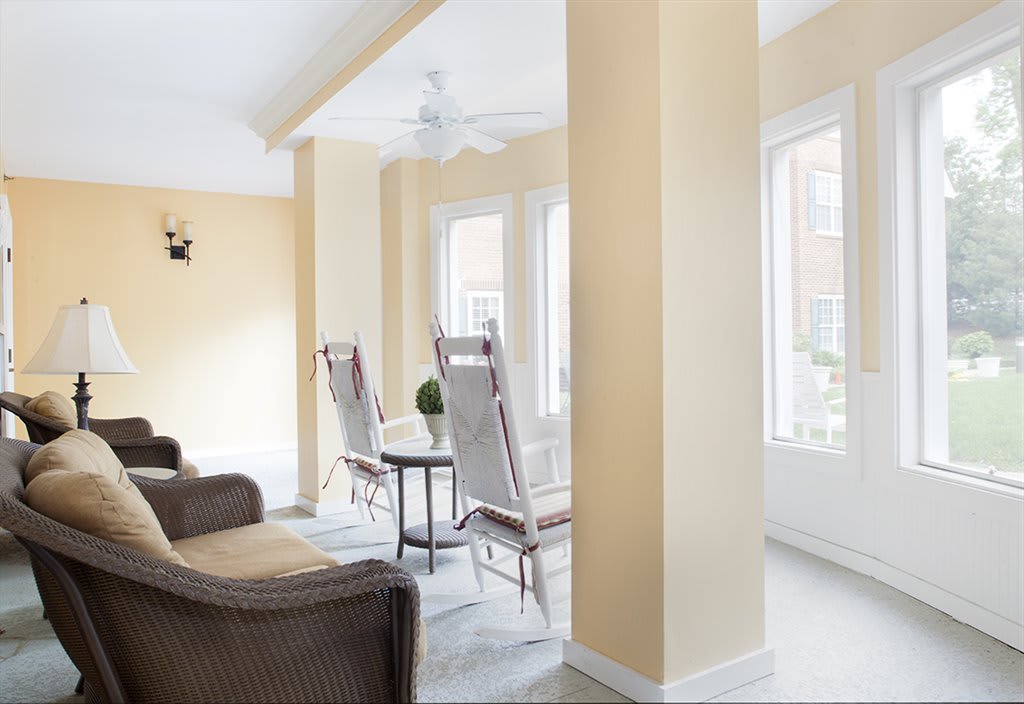A bright and airy living room with modern furniture and large windows allowing ample natural light.