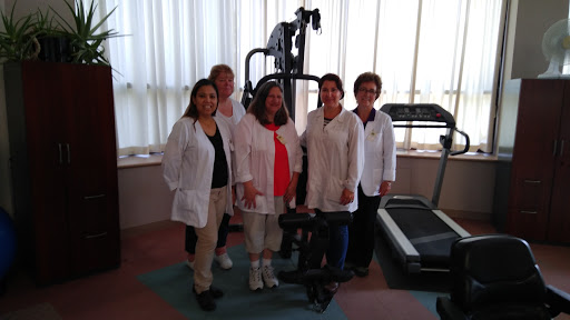 Healthcare professionals gathered in a fitness area, showcasing their commitment to wellness and rehabilitation.