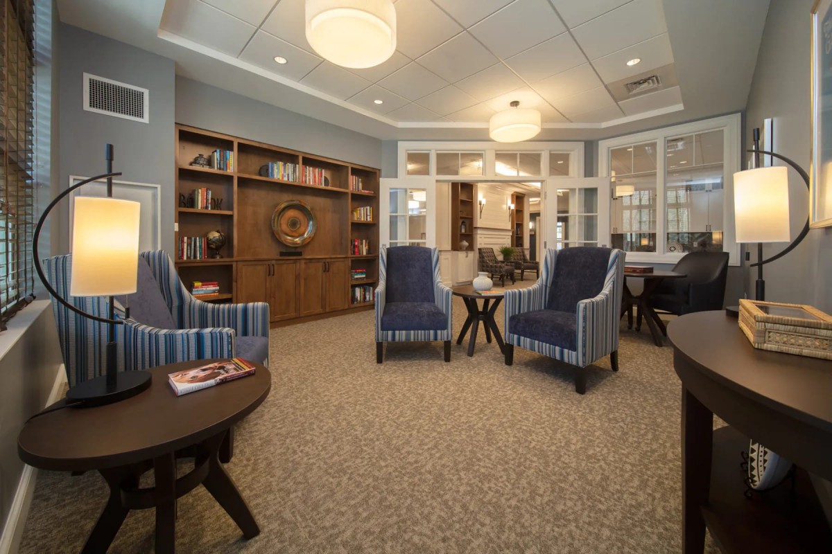 A cozy living room with comfortable seating and bookshelves.